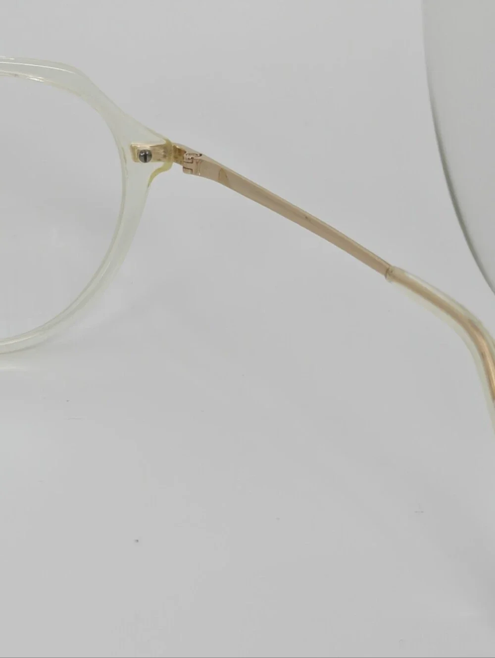 Tamara. Clear Round Frame Glasses. All Gold Accents are Metal.